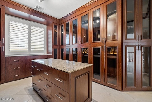 walk in closet with light tile patterned floors and visible vents