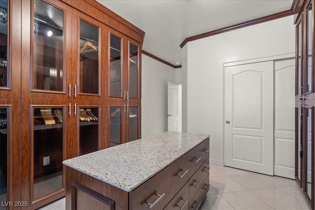 walk in closet with light tile patterned floors
