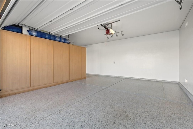 garage with baseboards and a garage door opener
