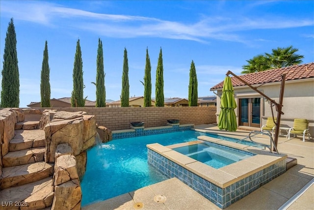 view of swimming pool featuring a patio area, an in ground hot tub, a fenced in pool, and a fenced backyard