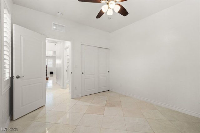 unfurnished bedroom with light tile patterned floors, baseboards, a closet, and visible vents