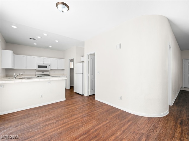 1153 Stormy Valley Rd, Las Vegas, NV 89123 - kitchen featuring white appliances, tile countertops, dark wood finished floors, white cabinets, and recessed lighting