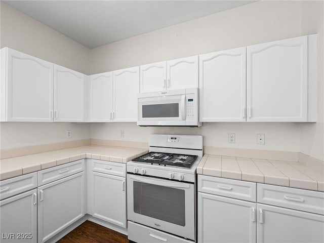 1153 Stormy Valley Rd, Las Vegas, NV 89123 - kitchen featuring white appliances, white cabinets, and tile countertops