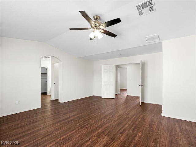 1153 Stormy Valley Rd, Las Vegas, NV 89123 - unfurnished room featuring lofted ceiling, dark wood-style flooring, ceiling fan, baseboards, and arched walkways