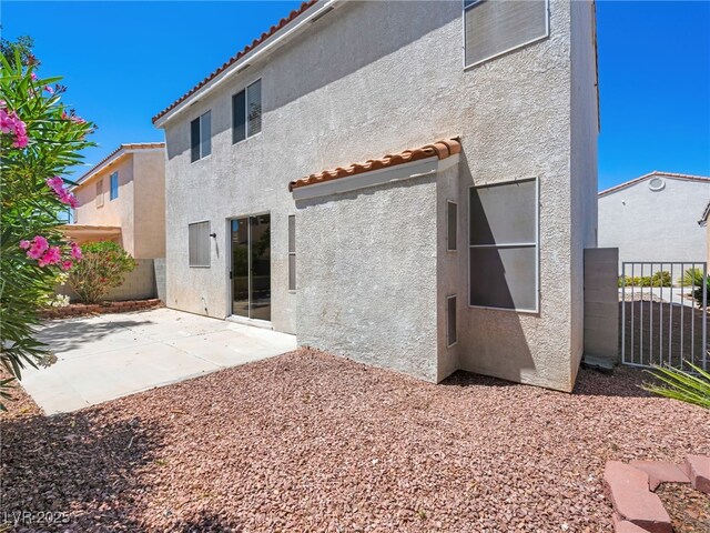 1153 Stormy Valley Rd, Las Vegas, NV 89123 - back of property featuring stucco siding, a tile roof, and a patio
