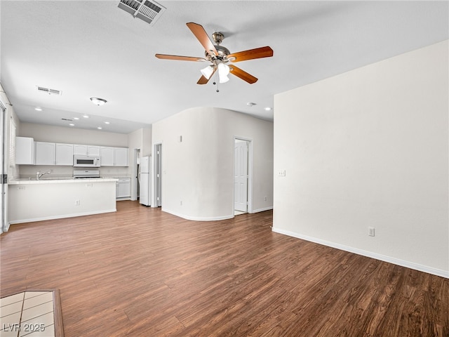1153 Stormy Valley Rd, Las Vegas, NV 89123 - unfurnished living room with a ceiling fan, wood finished floors, baseboards, recessed lighting, and a sink