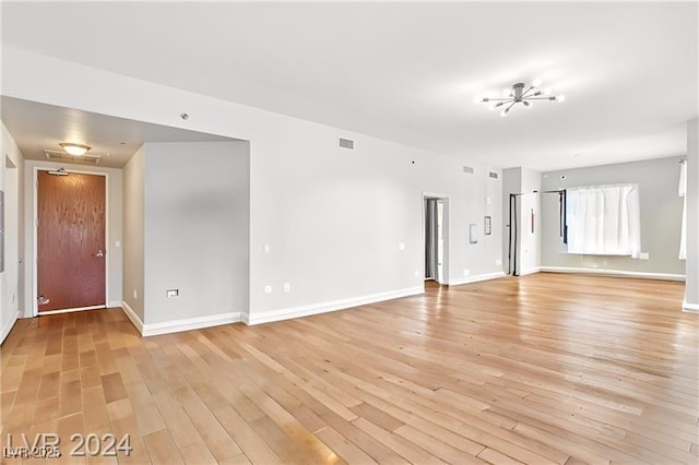 8255 Las Vegas Blvd Unit 713, Las Vegas, NV 89123 - unfurnished living room featuring light wood-style floors, visible vents, and baseboards