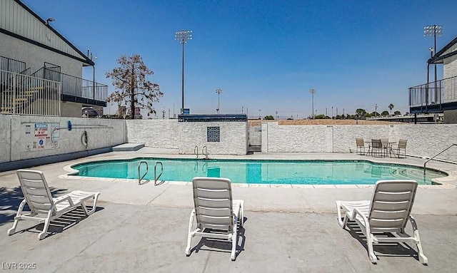 community pool featuring a patio area and fence