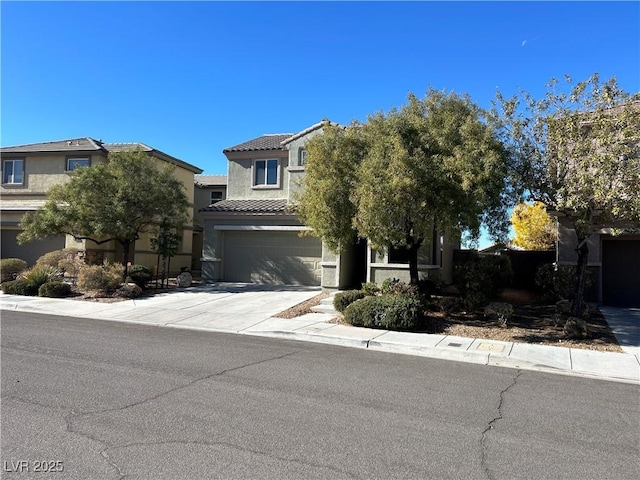 obstructed view of property featuring driveway, stucco siding, an attached garage, and a tile roof