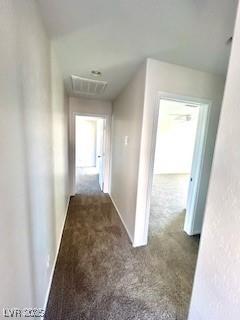 hall featuring baseboards and carpet floors