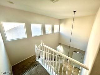 staircase featuring visible vents