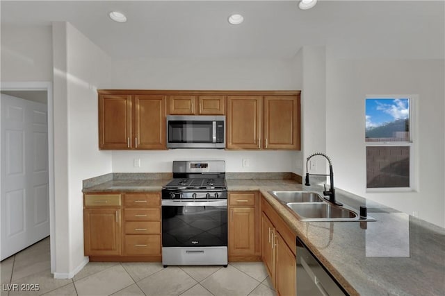 2749 Invermark St, Henderson, NV 89044 - kitchen with appliances with stainless steel finishes, light tile patterned floors, brown cabinets, recessed lighting, and light stone counters