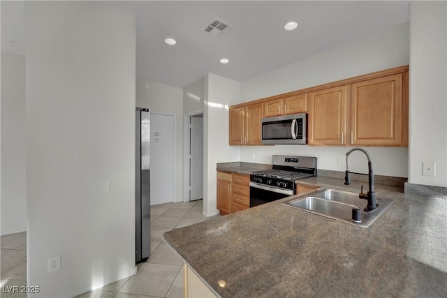 2749 Invermark St, Henderson, NV 89044 - kitchen with appliances with stainless steel finishes, dark countertops, light tile patterned flooring, and recessed lighting