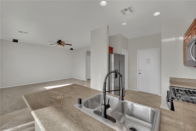 2749 Invermark St, Henderson, NV 89044 - kitchen featuring a ceiling fan, light colored carpet, recessed lighting, appliances with stainless steel finishes, and light tile patterned floors