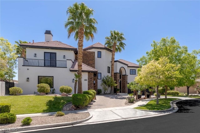 9501 Balatta Canyon Ct, Las Vegas, NV 89144 - mediterranean / spanish home with a balcony, a front yard, stucco siding, and a chimney