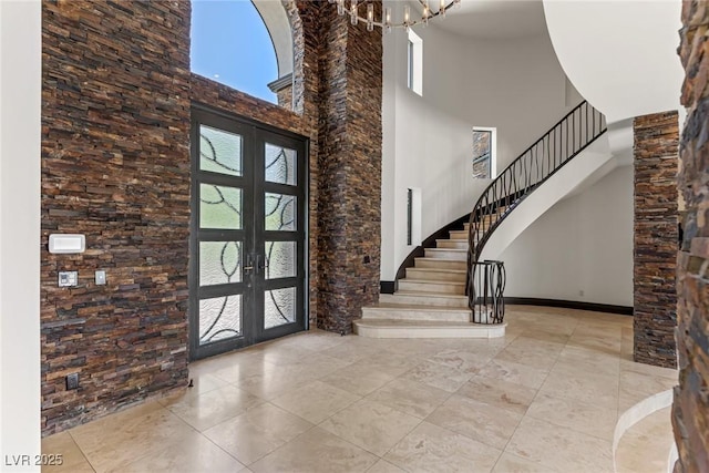 9501 Balatta Canyon Ct, Las Vegas, NV 89144 - tiled entryway featuring a notable chandelier, french doors, a towering ceiling, and stairway