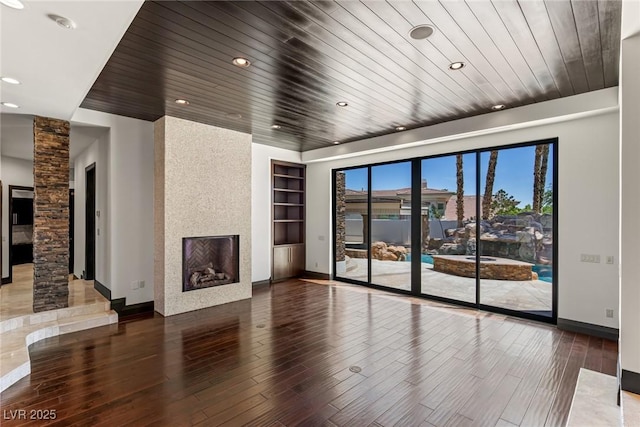 9501 Balatta Canyon Ct, Las Vegas, NV 89144 - unfurnished living room featuring wood ceiling, wood finished floors, ornate columns, a fireplace, and baseboards