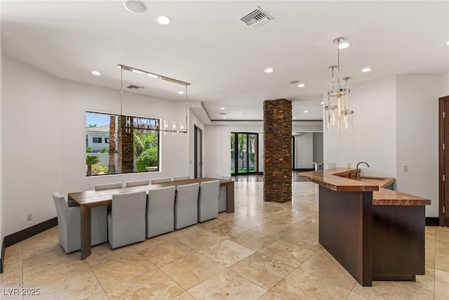 9501 Balatta Canyon Ct, Las Vegas, NV 89144 - kitchen featuring butcher block countertops, ornate columns, visible vents, and recessed lighting