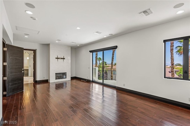 9501 Balatta Canyon Ct, Las Vegas, NV 89144 - unfurnished living room with a fireplace, baseboards, visible vents, and wood finished floors