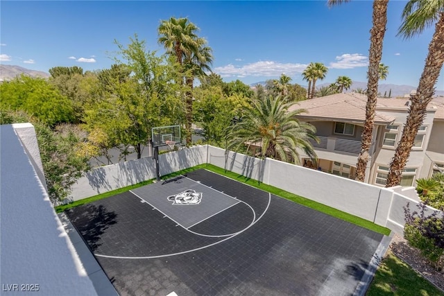 9501 Balatta Canyon Ct, Las Vegas, NV 89144 - view of sport court with a mountain view, fence, and basketball hoop