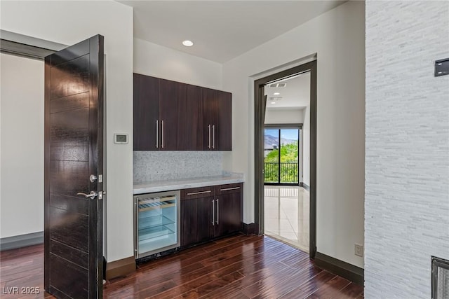 9501 Balatta Canyon Ct, Las Vegas, NV 89144 - bar with baseboards, dark wood-style flooring, tasteful backsplash, and beverage cooler