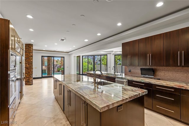 9501 Balatta Canyon Ct, Las Vegas, NV 89144 - kitchen featuring stainless steel appliances, a kitchen island with sink, backsplash, healthy amount of natural light, and recessed lighting