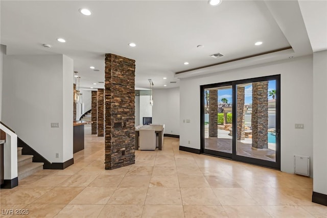 9501 Balatta Canyon Ct, Las Vegas, NV 89144 - unfurnished living room featuring recessed lighting, baseboards, visible vents, stairway, and ornate columns