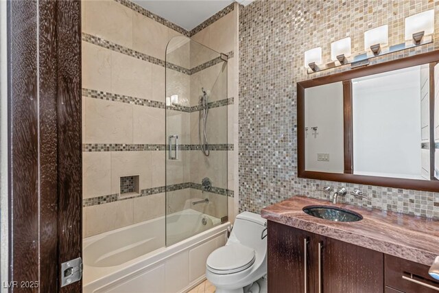 9501 Balatta Canyon Ct, Las Vegas, NV 89144 - bathroom with tile walls, toilet, vanity, washtub / shower combination, and backsplash