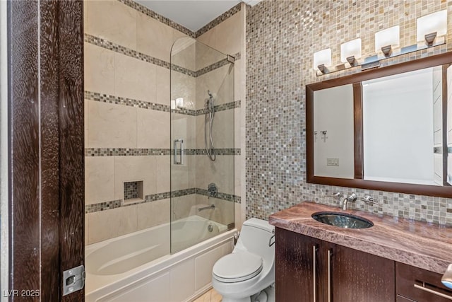 9501 Balatta Canyon Ct, Las Vegas, NV 89144 - bathroom featuring tile walls, vanity, shower / bath combination with glass door, and decorative backsplash