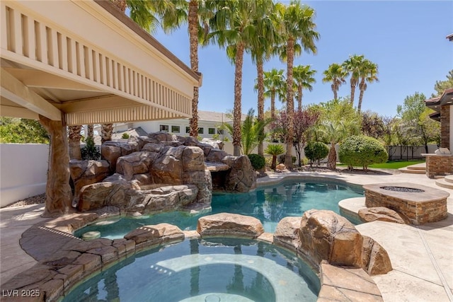 9501 Balatta Canyon Ct, Las Vegas, NV 89144 - view of pool with an outdoor fire pit, a patio area, a pool with connected hot tub, and fence