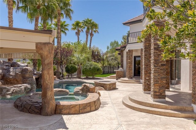 9501 Balatta Canyon Ct, Las Vegas, NV 89144 - view of patio / terrace with an in ground hot tub, an outdoor pool, and a balcony