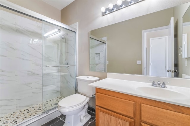 bathroom featuring a marble finish shower, toilet, vanity, and tile patterned floors