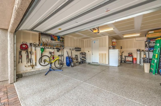 8257 Skye Peak St, Las Vegas, NV 89166 - garage with freestanding refrigerator and a garage door opener