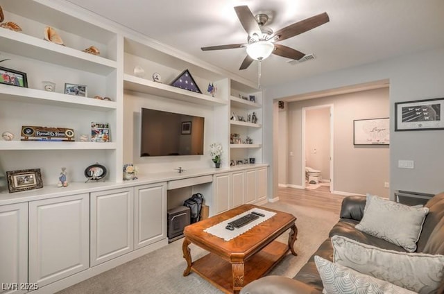 8257 Skye Peak St, Las Vegas, NV 89166 - living area with a ceiling fan, light colored carpet, and built in shelves