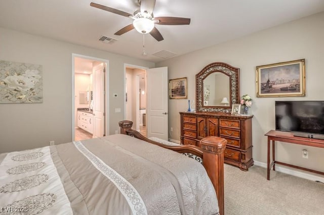 8257 Skye Peak St, Las Vegas, NV 89166 - bedroom with light colored carpet, baseboards, ensuite bath, and ceiling fan