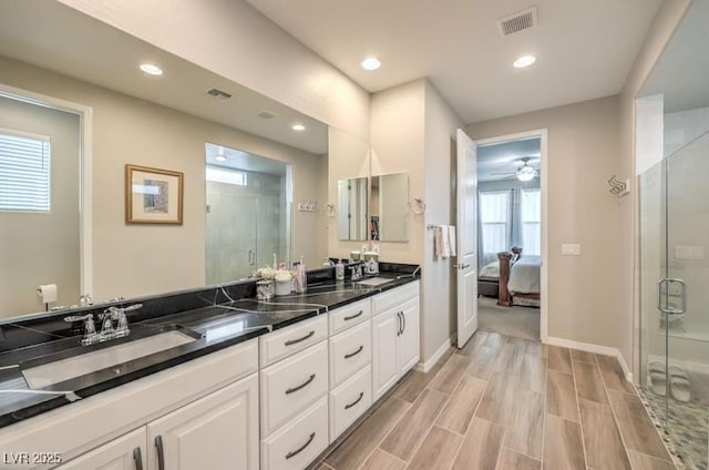 8257 Skye Peak St, Las Vegas, NV 89166 - bathroom with a shower stall, double vanity, recessed lighting, ceiling fan, and baseboards