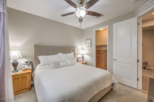 8257 Skye Peak St, Las Vegas, NV 89166 - bedroom with light colored carpet, a ceiling fan, and a walk in closet