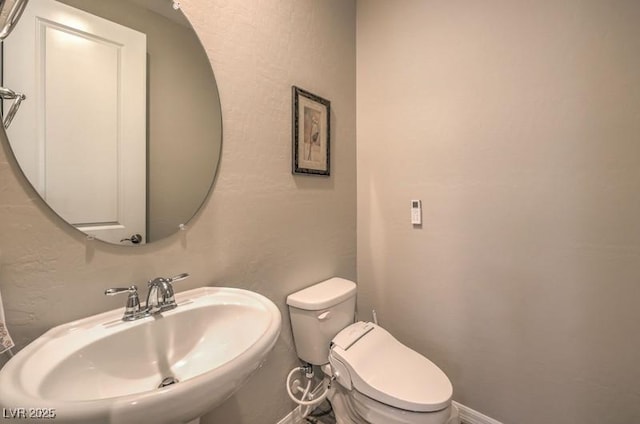 8257 Skye Peak St, Las Vegas, NV 89166 - half bathroom featuring a sink and toilet