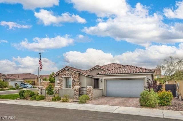 8257 Skye Peak St, Las Vegas, NV 89166 - mediterranean / spanish-style home featuring a tiled roof, stucco siding, decorative driveway, a garage, and stone siding