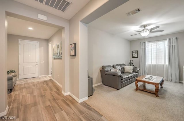 8257 Skye Peak St, Las Vegas, NV 89166 - living area featuring light wood-style flooring, a ceiling fan, and baseboards
