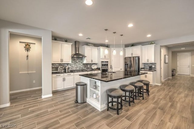8257 Skye Peak St, Las Vegas, NV 89166 - kitchen with appliances with stainless steel finishes, wall chimney range hood, dark countertops, a breakfast bar, and white cabinetry