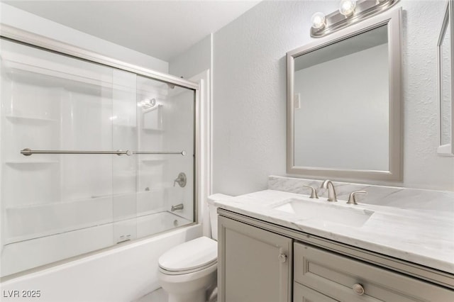 3066 Tarpon Dr Unit 204, Las Vegas, NV 89120 - full bathroom with vanity, toilet, a textured wall, and enclosed tub / shower combo