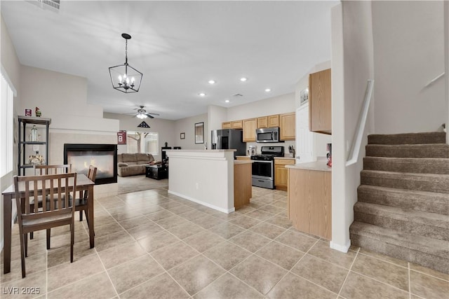 kitchen featuring stainless steel appliances, recessed lighting, open floor plan, light countertops, and light brown cabinets
