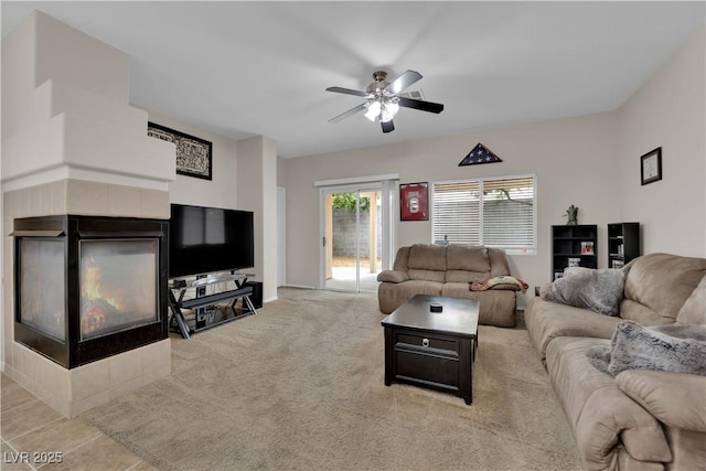 carpeted living area with a ceiling fan