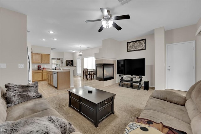 living room with ceiling fan and recessed lighting