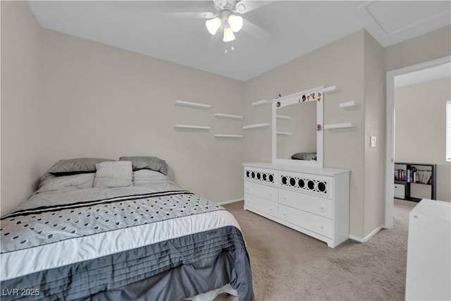 carpeted bedroom with baseboards, ceiling fan, and attic access