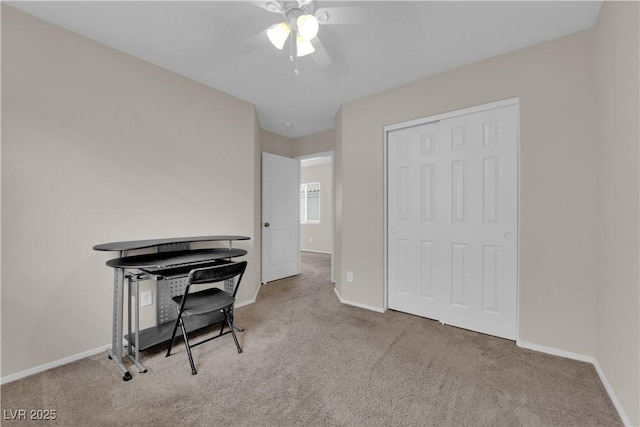 office space with carpet, baseboards, and a ceiling fan