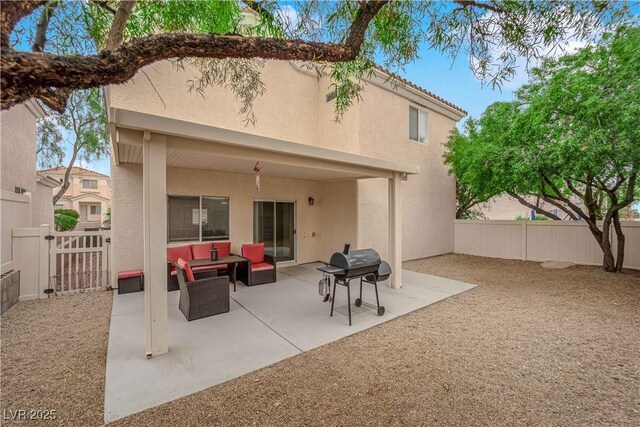 back of property with a fenced backyard, a patio area, outdoor lounge area, and stucco siding
