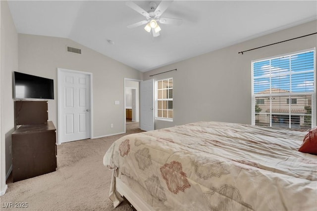 bedroom with carpet flooring, a ceiling fan, visible vents, baseboards, and vaulted ceiling
