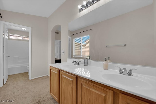 bathroom with plenty of natural light, double vanity, and a sink